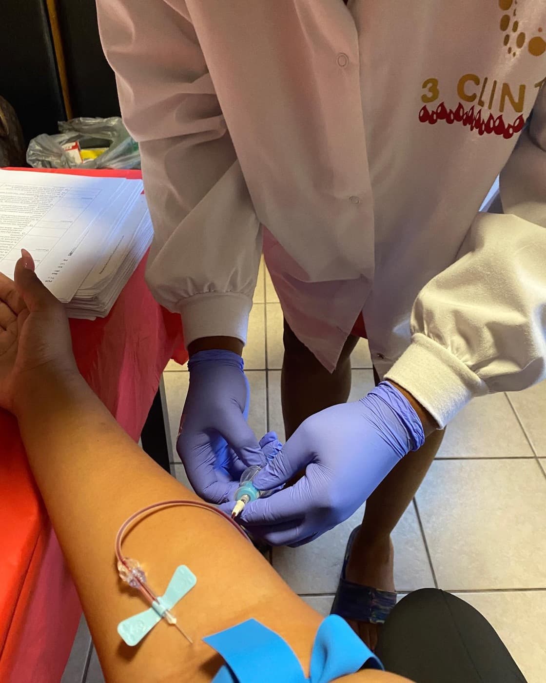 A student practicing venipuncture technique during hands-on phlebotomy training